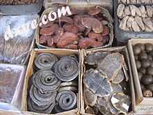 Assorted dried plant and animal parts used in traditional Chinese medicines, clockwise from top left ...